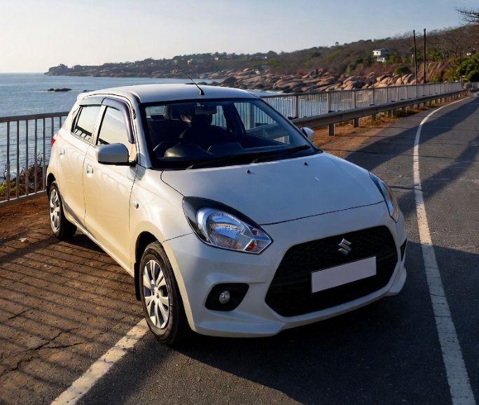 compact hatchback parked near a coastal road in Goa